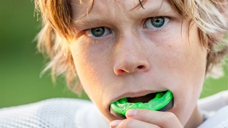 young football player with mouthguard