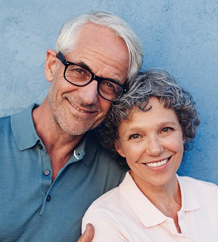 Older couple with healthy happy smiles