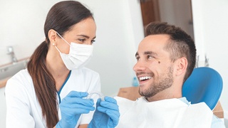 dentist and male patient discussing SureSmile Aligner treatment