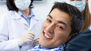 Young man smiling in dental chair