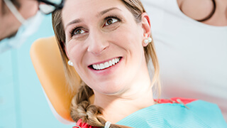 Happy woman smiling in dental chair