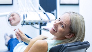 Woman in dental chair after cosmetic dentistry in Lakeville, MA