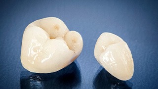 two dental crowns on blue gradient background
