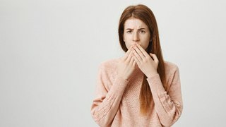 Woman with toothache who may need a dental crown