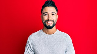 Smiling young man enjoying benefits of dental crowns