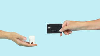 Person using card to pay for dental treatment