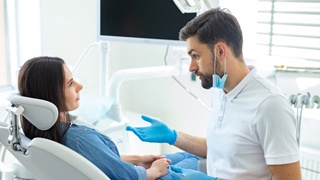 Dentist in Lakeville giving woman extraction aftercare instructions