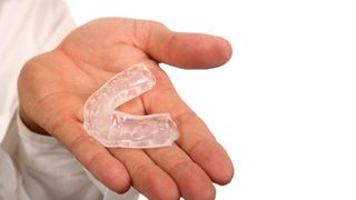 Closeup of mouthguard for protecting dental implants in Lakeville