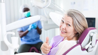 Woman caring for her dental implants in Lakeville via checkup
