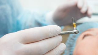 Dentist preparing to place dental implant in patient’s mouth