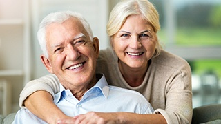Senior couple enjoying money-saving benefits of dental implants