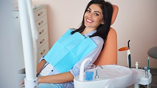 Happy dental patient, glad she could afford dental implants