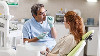 dentist explaining dental implant salvage in Lakeville 