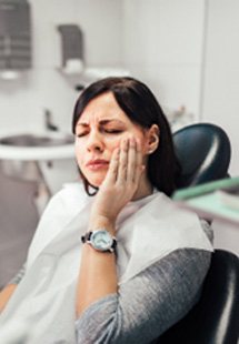 Woman with toothache at dentist's office in New Bedford