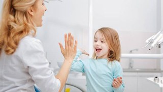 Girl high-fiving dentist