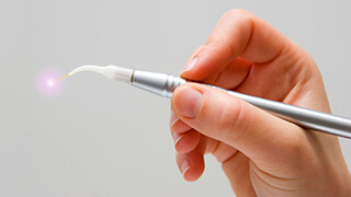 Handheld laser dentistry tool