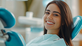 Smiling young woman in dental treatment chair