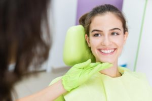 a woman smiling in the dentist chair