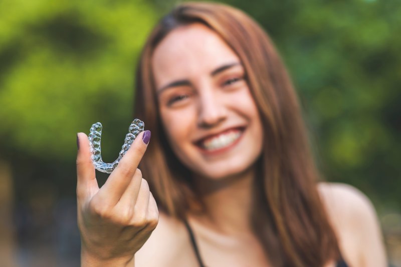 young woman putting on her suresmile aligner
