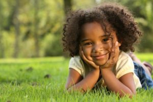 young girl smiling curly hair