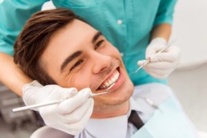 a young man having his teeth checked