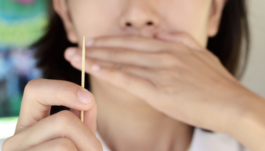 Woman holding toothpick